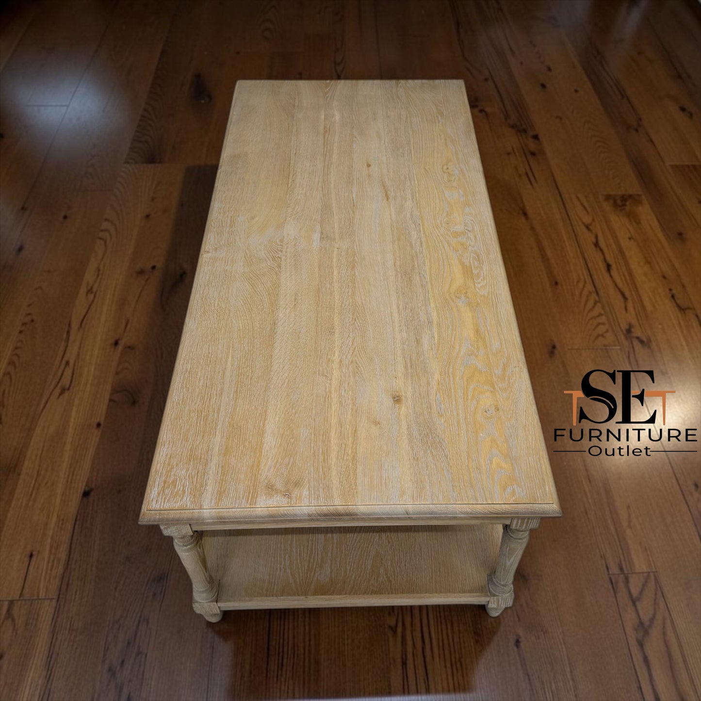 Wooden coffee table on a wooden floor with 'SET Furniture Outlet' branding.