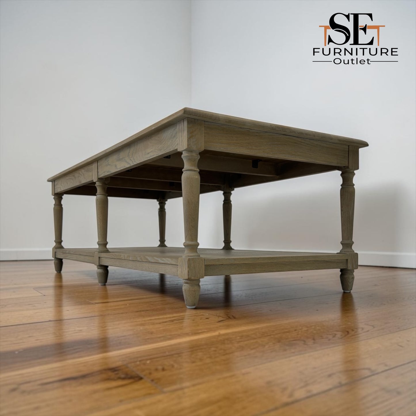 Wooden table on a wooden floor with 'SET Furniture Outlet' branding.


