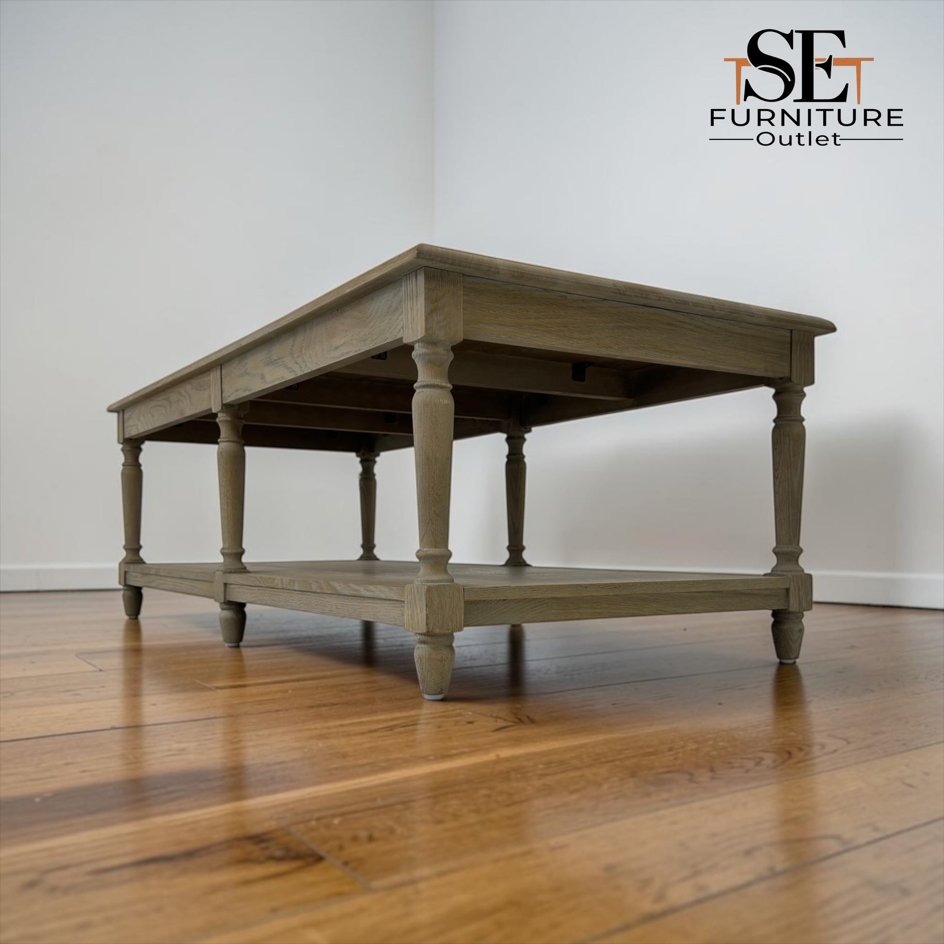 Wooden table on a wooden floor with 'SET Furniture Outlet' branding.

