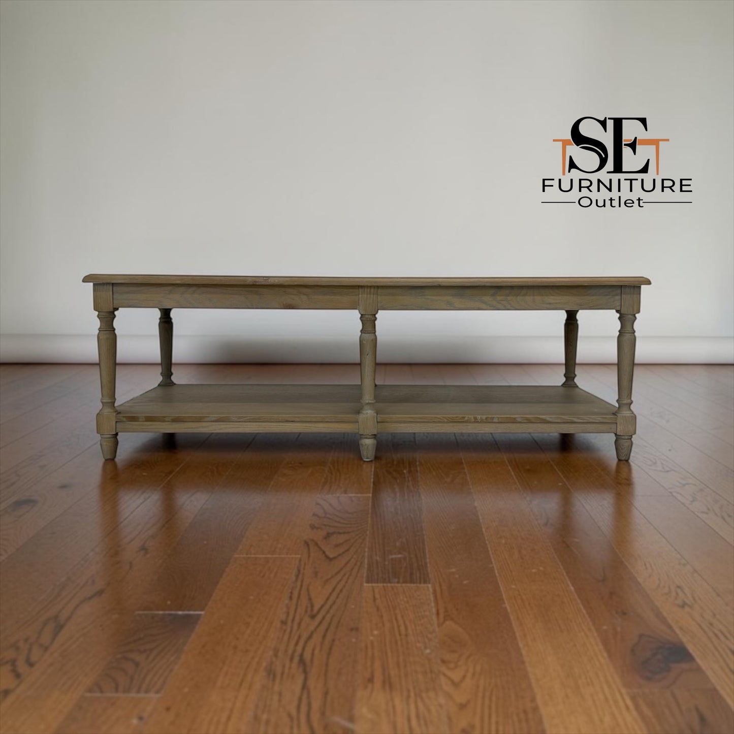 Wooden table on a wooden floor with 'SE Furniture Outlet' logo.

