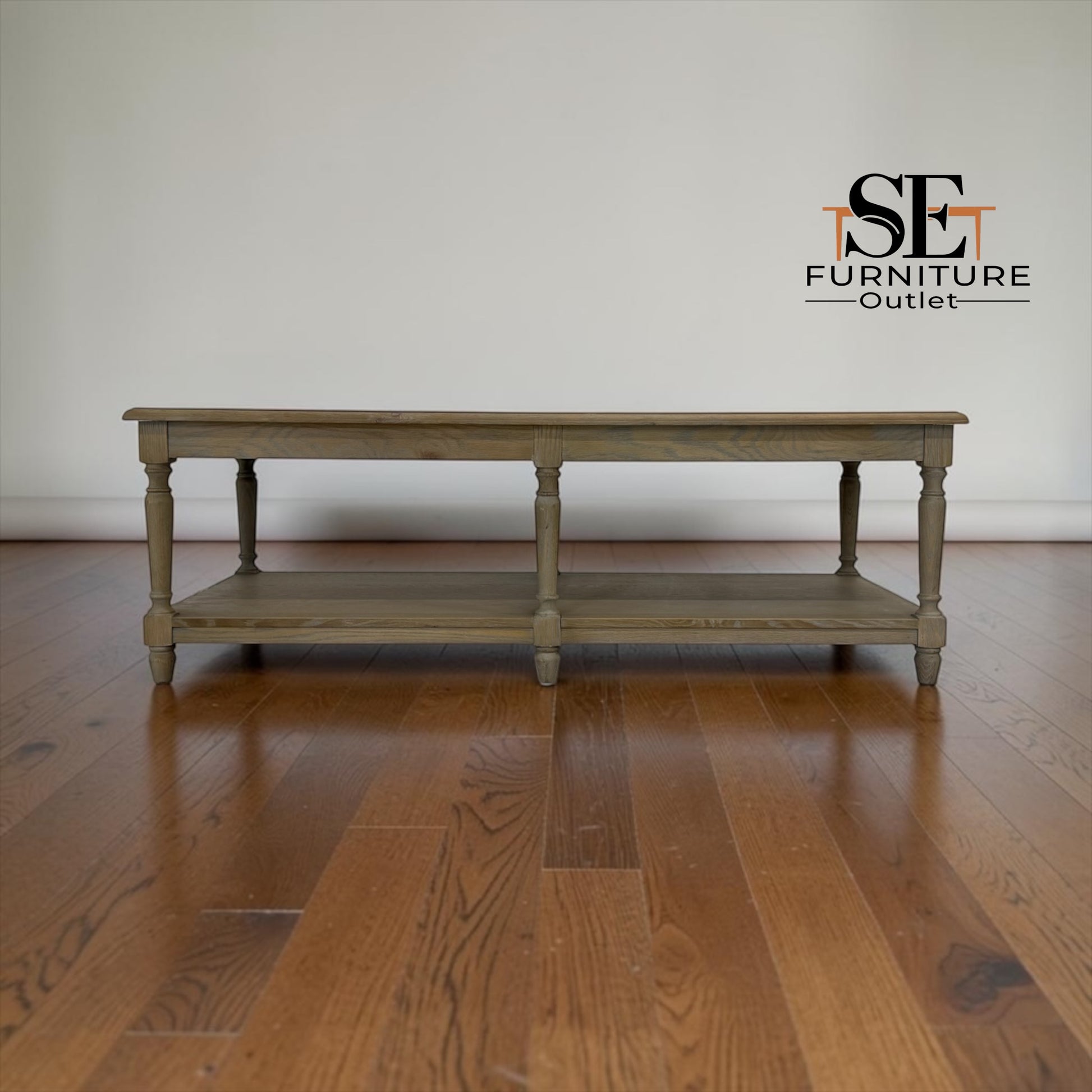 Wooden table on a wooden floor with 'SE Furniture Outlet' logo.

