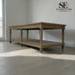 Wooden table with a shelf in a room with a light gray floor and white walls, featuring the SET Furniture Outlet logo.


